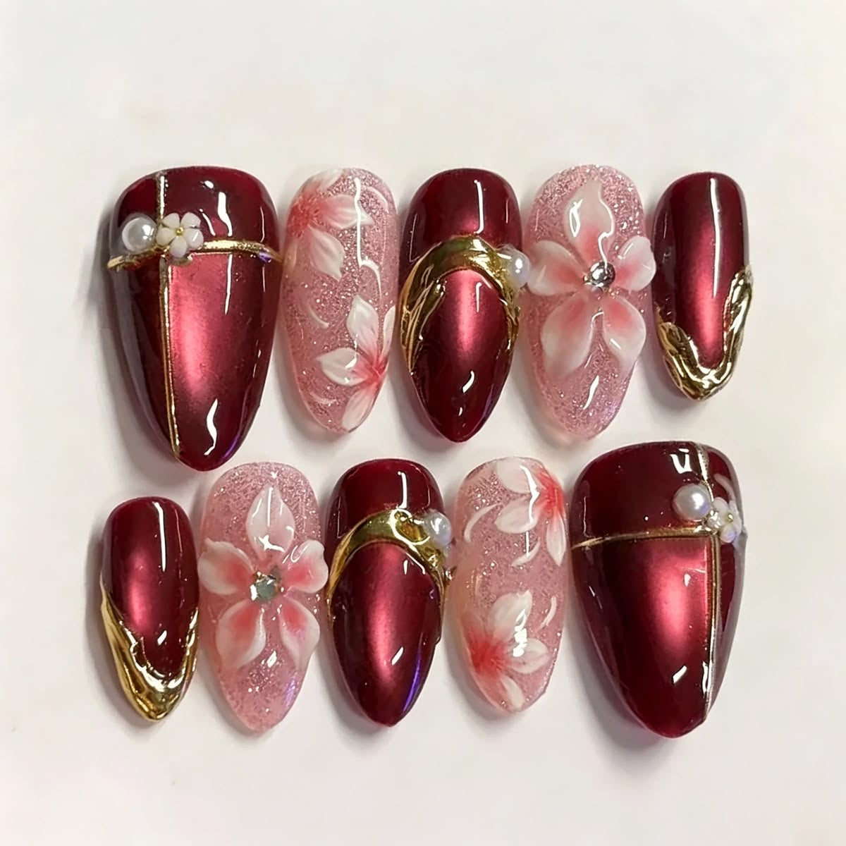 Red cat eye nails with pink flowers