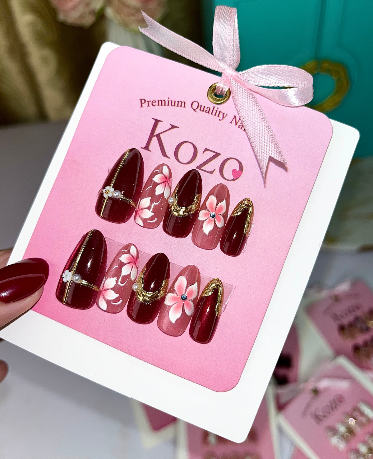 Red cat eye nails with pink flowers