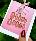 Brown short oval French tips with golden bow
