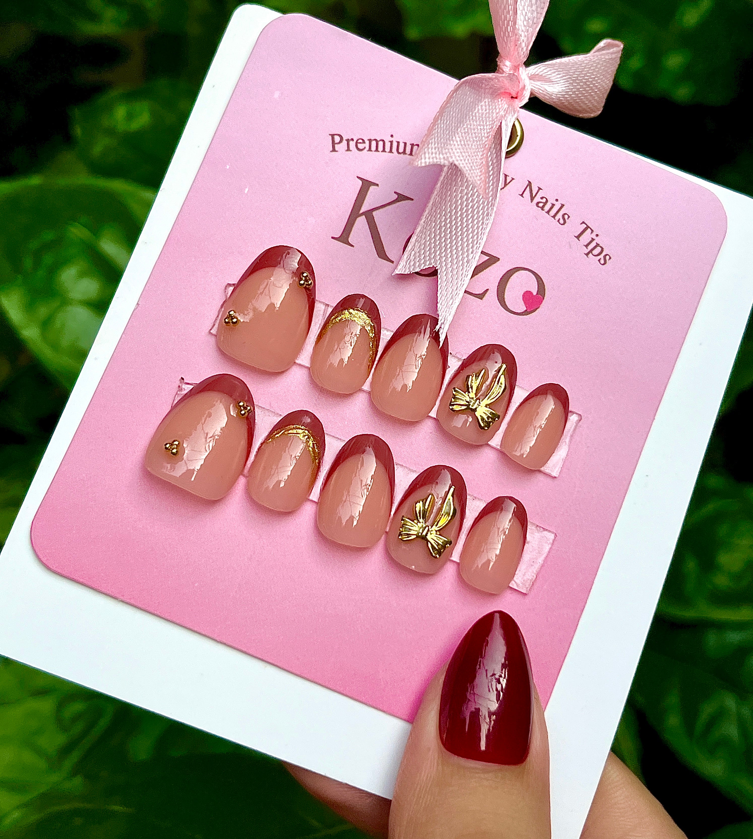 Brown short oval French tips with golden bow
