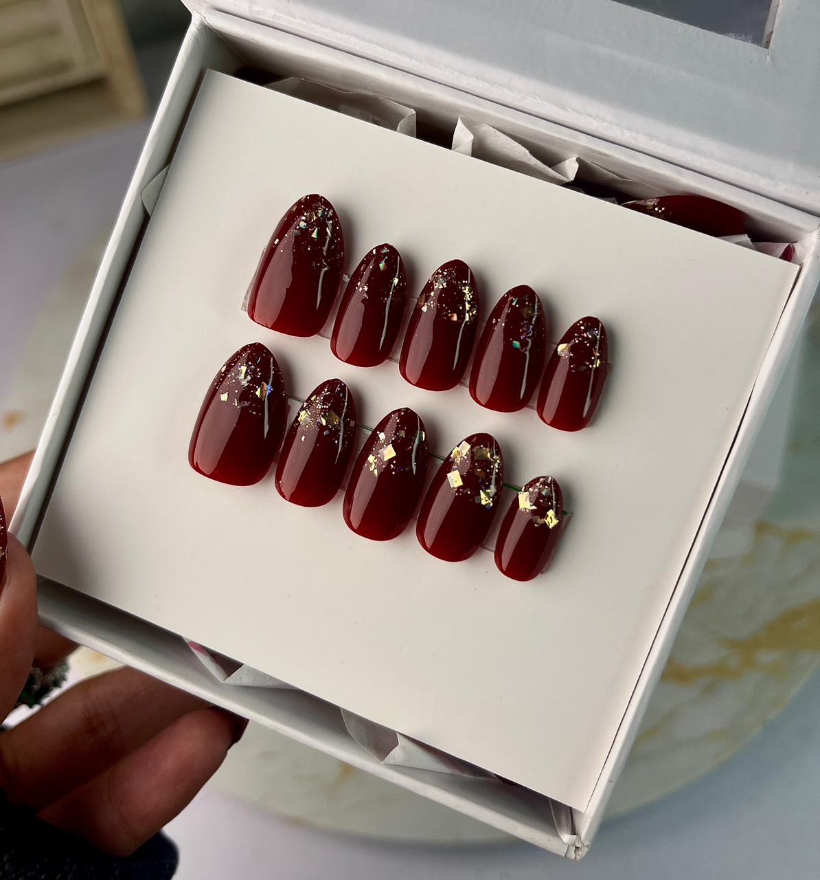 Cherry red nails with golden glitter