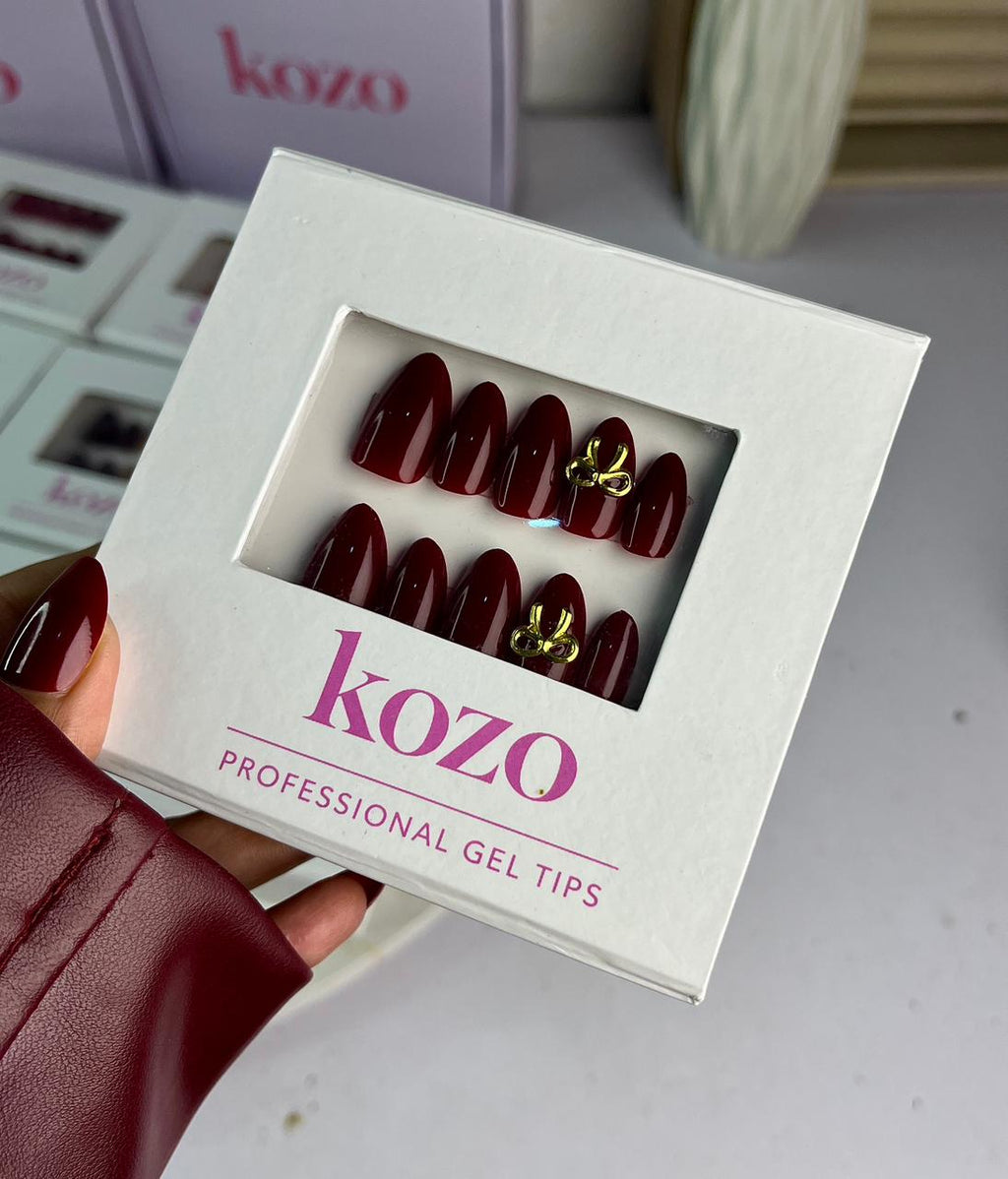 Cherry red nails with golden bow