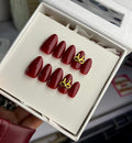Cherry red nails with golden bow